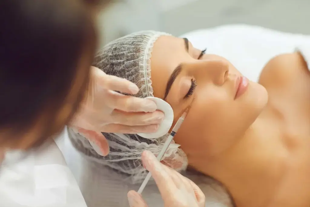 A clinician marking the area above a patient brow before treatment