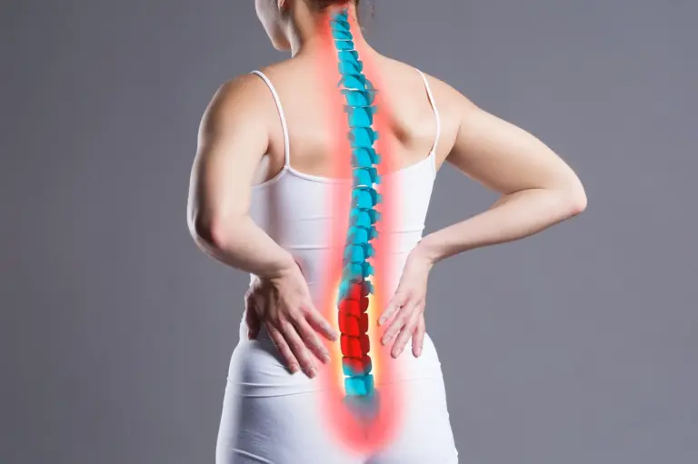 Illustration of the spine over a person's back with the lumbar region highlighted