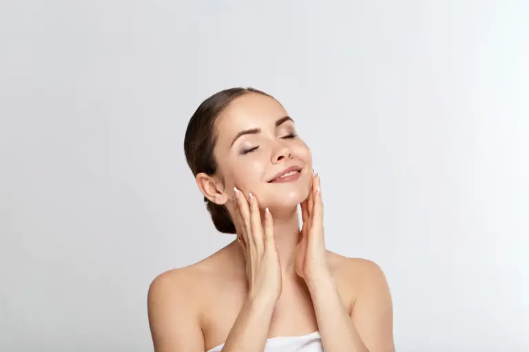 Woman resting her hands against her cheeks with her eyes closed